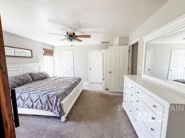 808 O'Leary Way Twin Falls, ID 83301 - Photo 19 of 37 Carpeted room with a ceiling fan, light gray walls, white trim, and multiple white doors