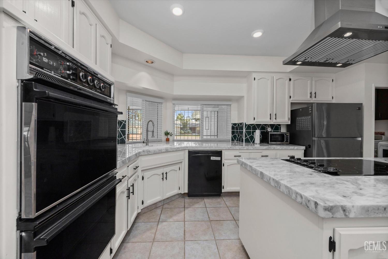Undisclosed Address Bakersfield, CA 93311 - Photo 16 of 34 a kitchen with granite countertop a refrigerator stove and sink