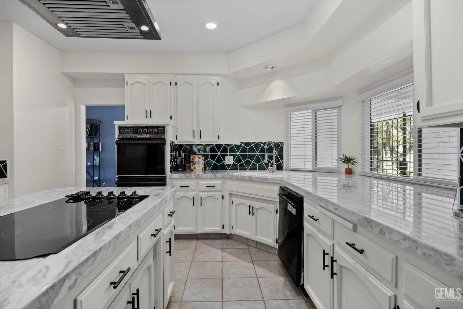 Undisclosed Address Bakersfield, CA 93311 - Photo 17 of 34 a kitchen with stainless steel appliances a stove sink microwave and cabinets