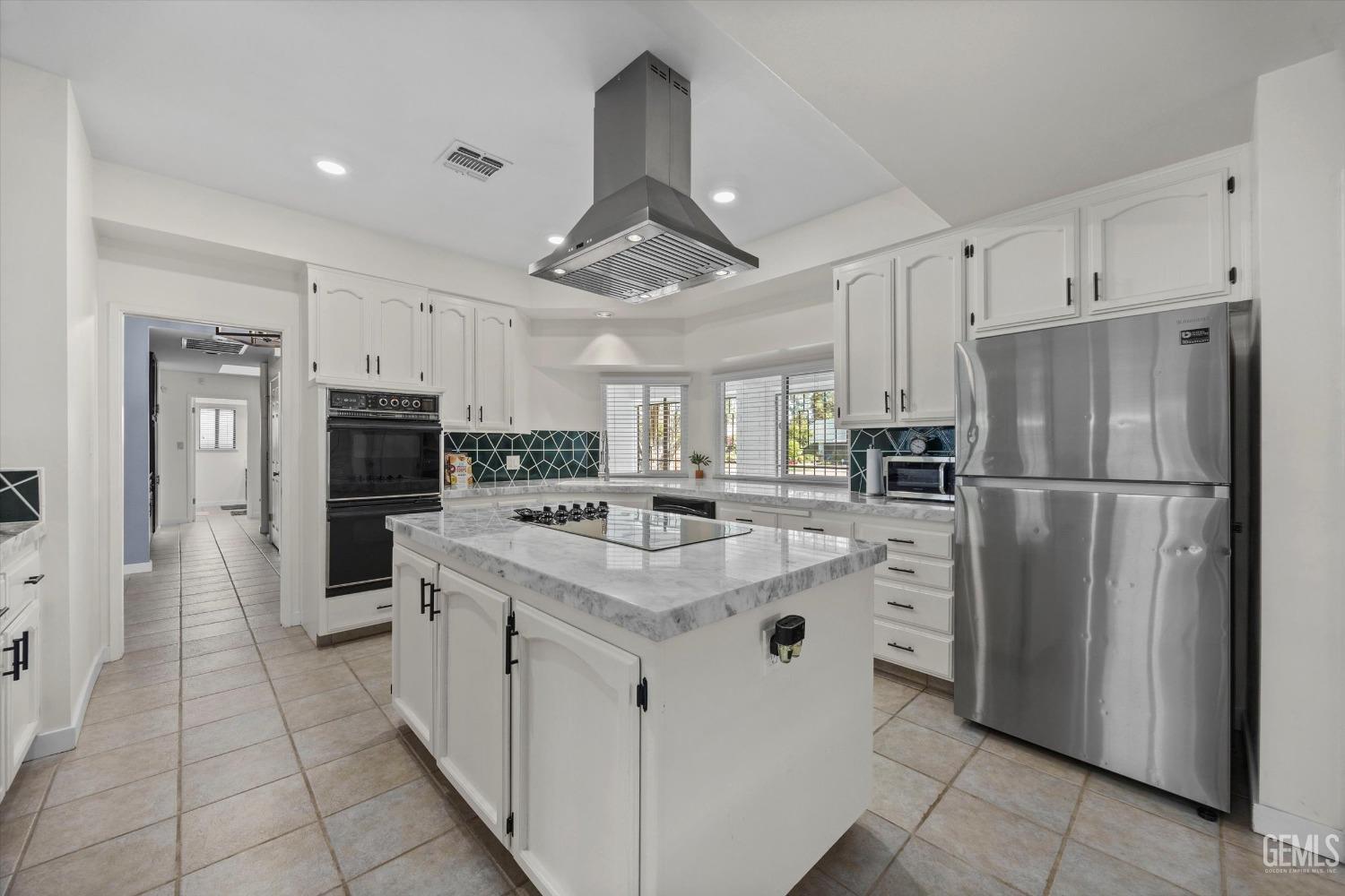 Undisclosed Address Bakersfield, CA 93311 - Photo 19 of 34 a kitchen with stainless steel appliances a refrigerator sink and microwave