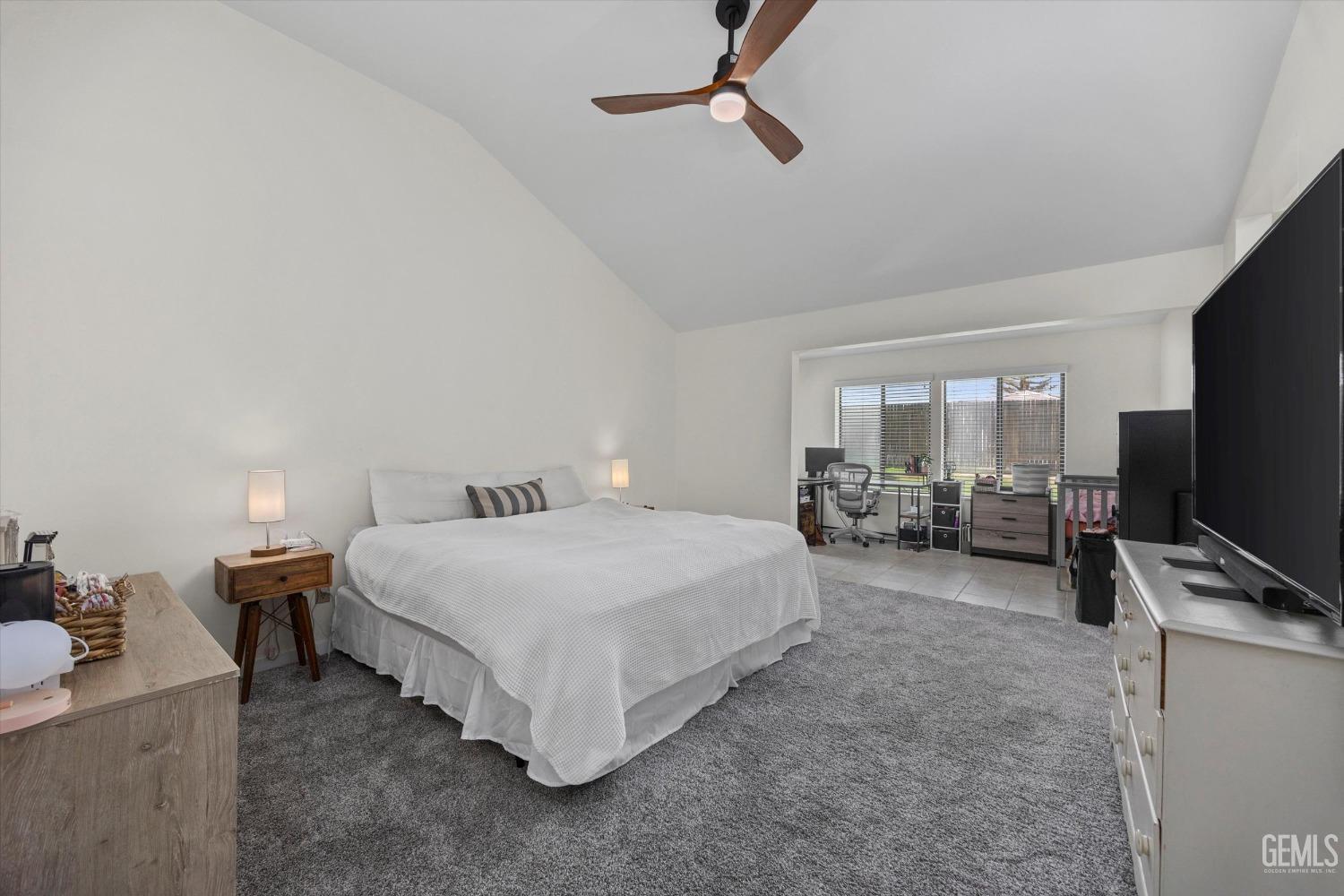 Undisclosed Address Bakersfield, CA 93311 - Photo 20 of 34 a spacious bedroom with a bed and a flat screen tv