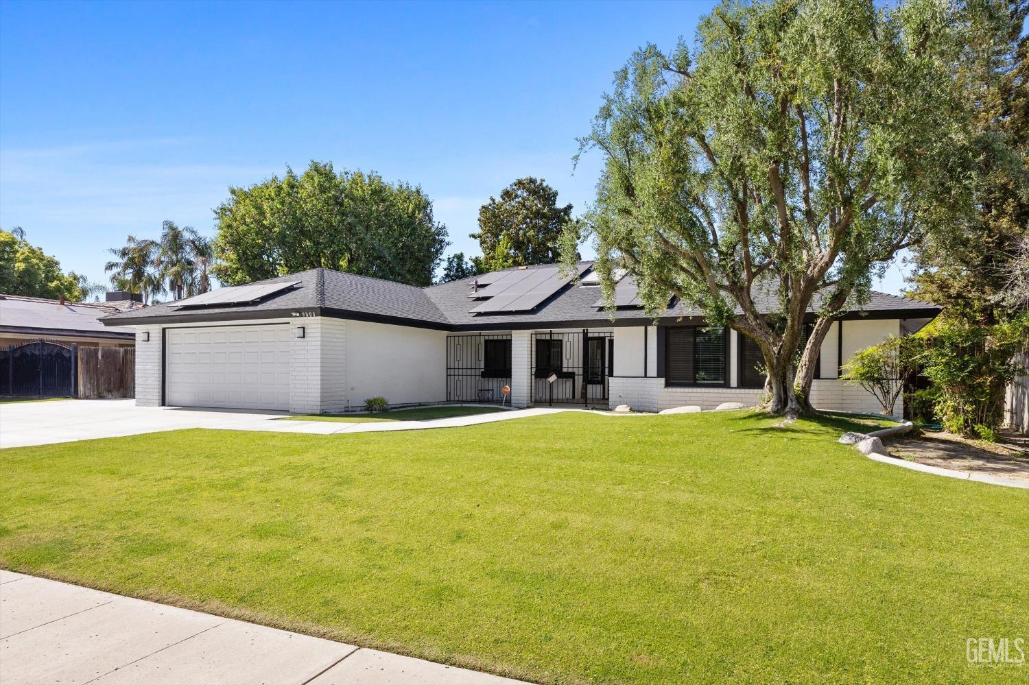 Undisclosed Address Bakersfield, CA 93311 - Photo 2 of 34 a front view of house with yard and trees in the background