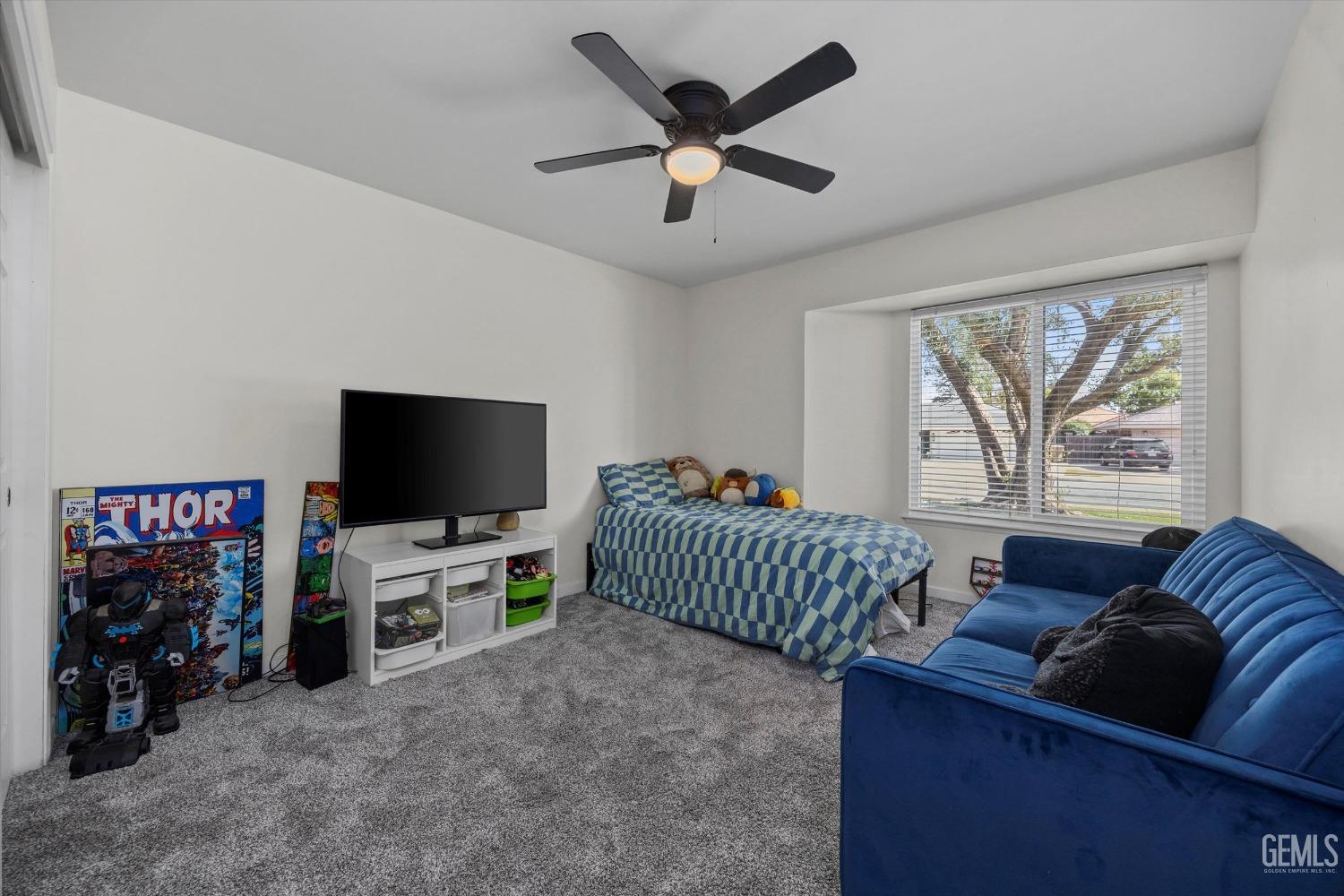Undisclosed Address Bakersfield, CA 93311 - Photo 25 of 34 a living room with furniture and a flat screen tv