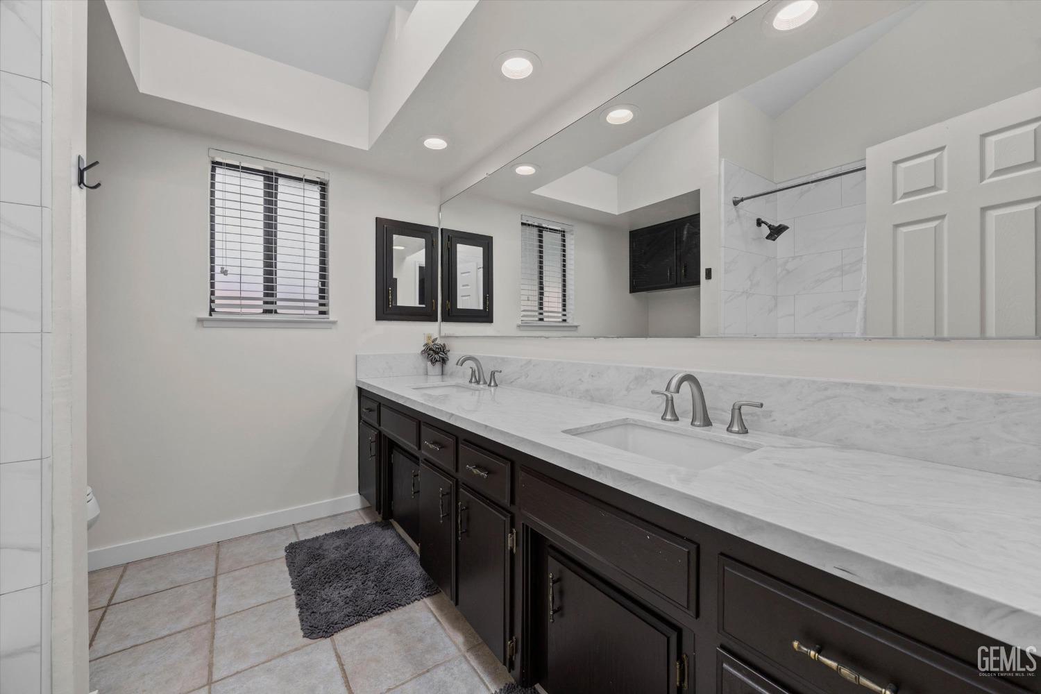 Undisclosed Address Bakersfield, CA 93311 - Photo 26 of 34 a bathroom with a sink double vanity and a mirror