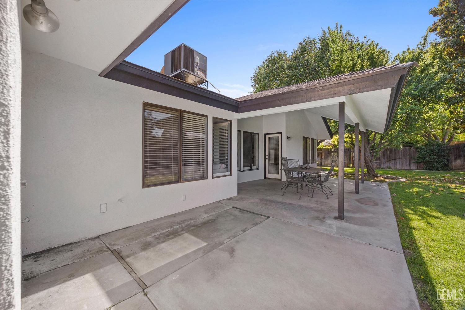 Undisclosed Address Bakersfield, CA 93311 - Photo 33 of 34 a view of a patio with table and chairs potted plants with floor to ceiling window and potted plants