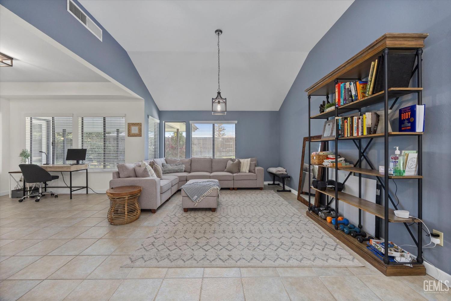 Undisclosed Address Bakersfield, CA 93311 - Photo 7 of 34 a living room with lots of furniture and a book shelf