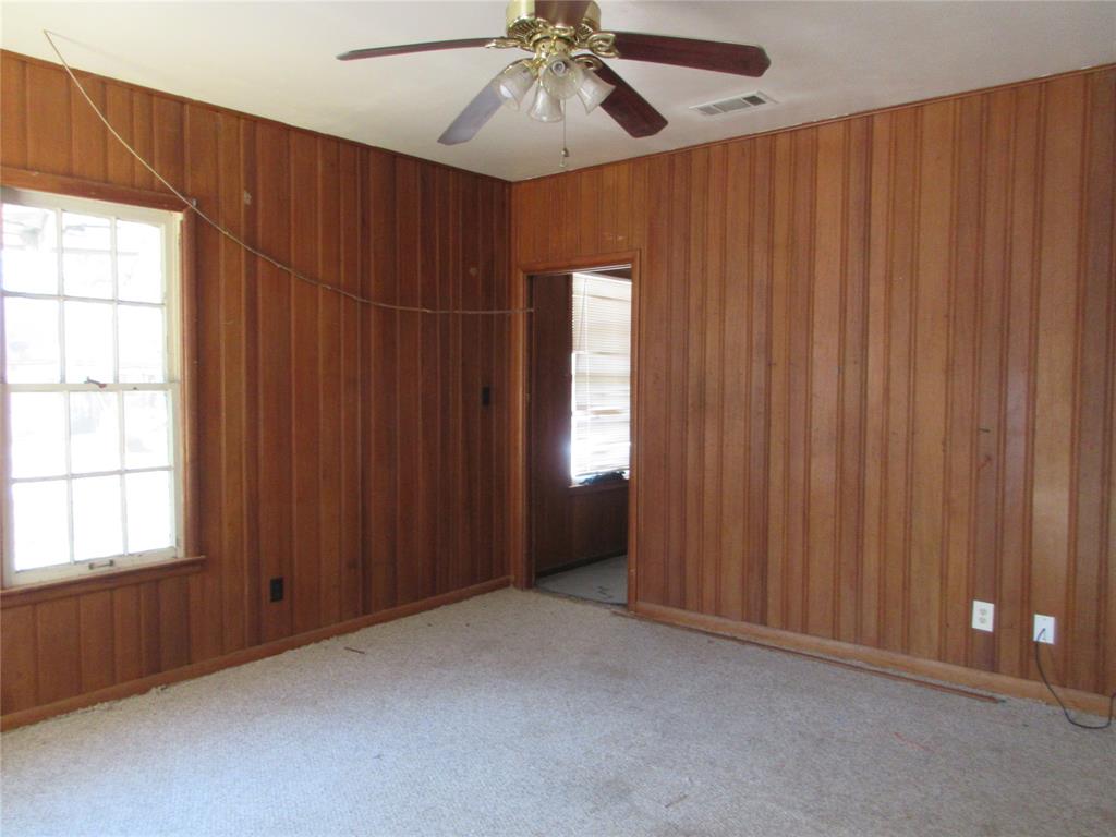 916 Ward Street Marlin, TX 76661 - Photo 2 of 13 an empty room with windows and fan