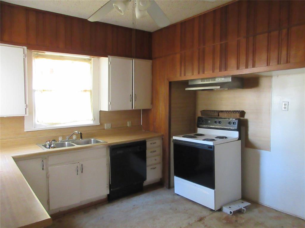 916 Ward Street Marlin, TX 76661 - Photo 6 of 13 a kitchen with a stove sink and cabinets