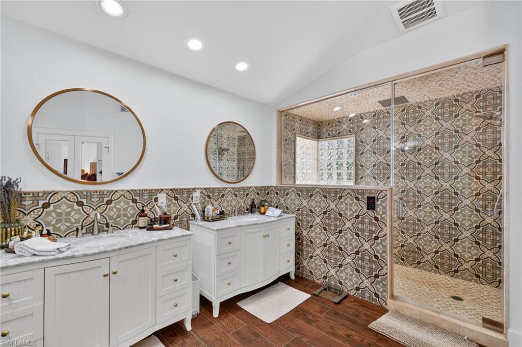 175 Palm River Boulevard Naples, FL 34110 - Photo 27 of 45 a bathroom with a sink a mirror and a shower