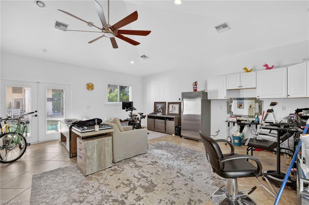 175 Palm River Boulevard Naples, FL 34110 - Photo 35 of 45 a view of a workspace with furniture and a kitchen