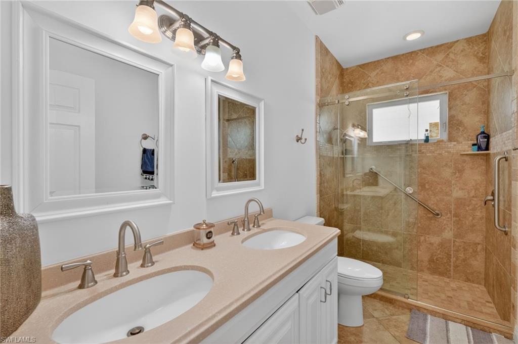 175 Palm River Boulevard Naples, FL 34110 - Photo 36 of 45 a bathroom with a sink toilet and shower