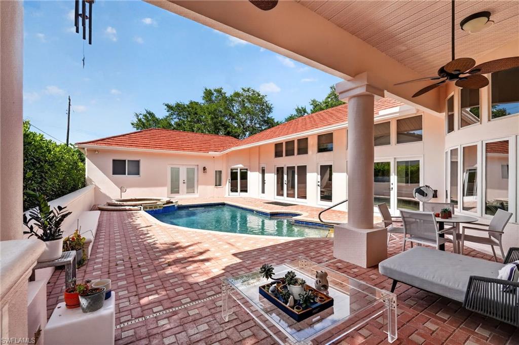175 Palm River Boulevard Naples, FL 34110 - Photo 42 of 45 a front view of a house with swimming pool