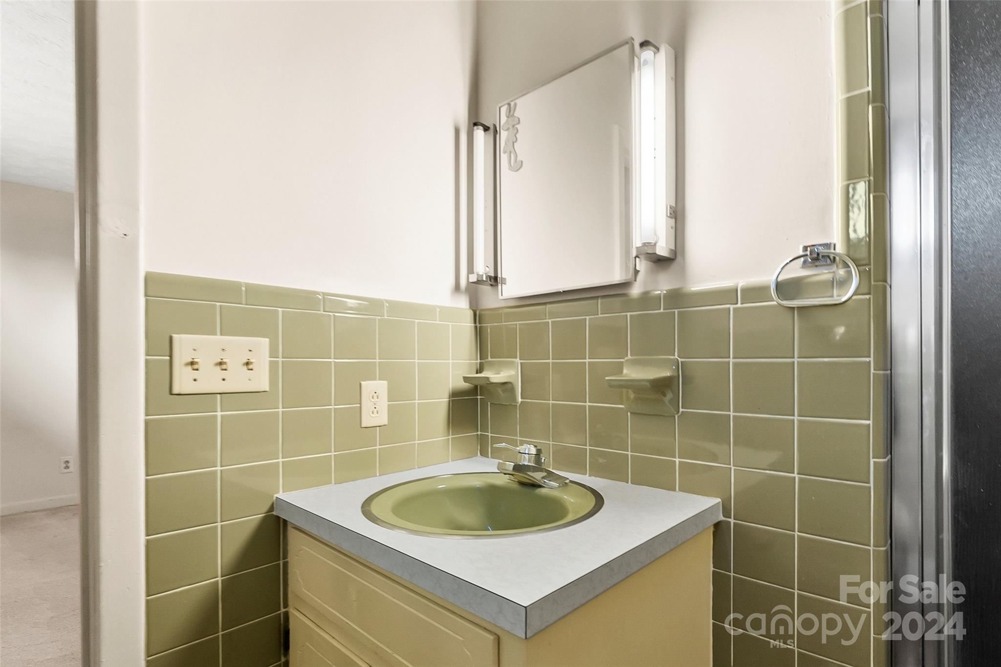 110 Stephens Drive Morganton, NC 28655 - Photo 14 of 29 a bathroom with a sink and a mirror
