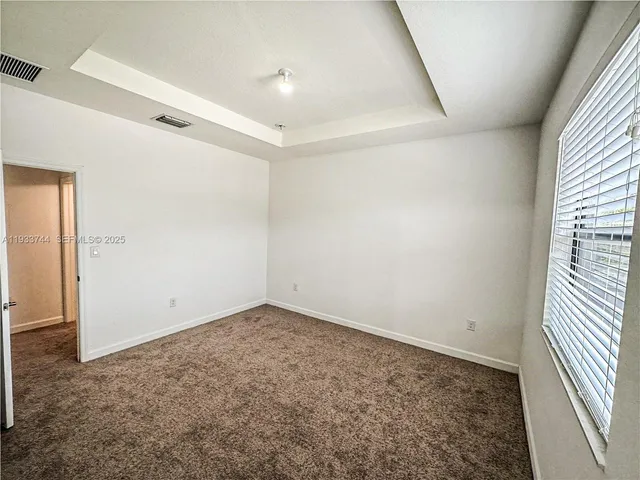 an empty room with a empty space and windows