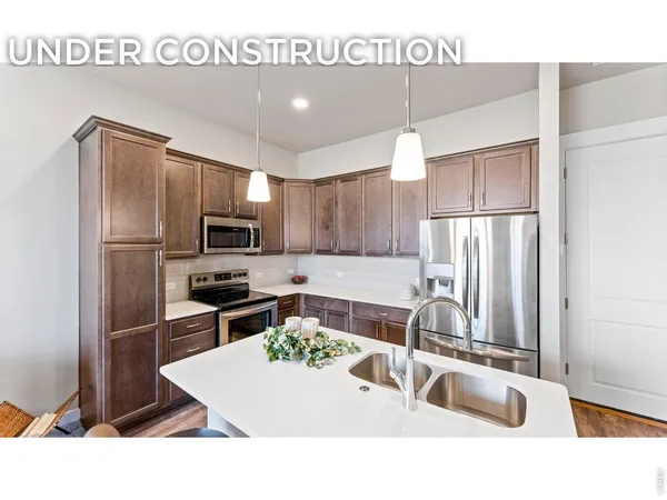 a kitchen with stainless steel appliances granite countertop a sink refrigerator and microwave