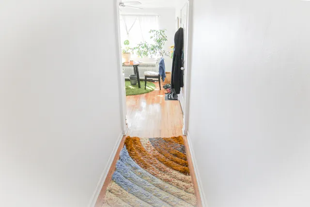 a view of a dining room with furniture and a potted plant