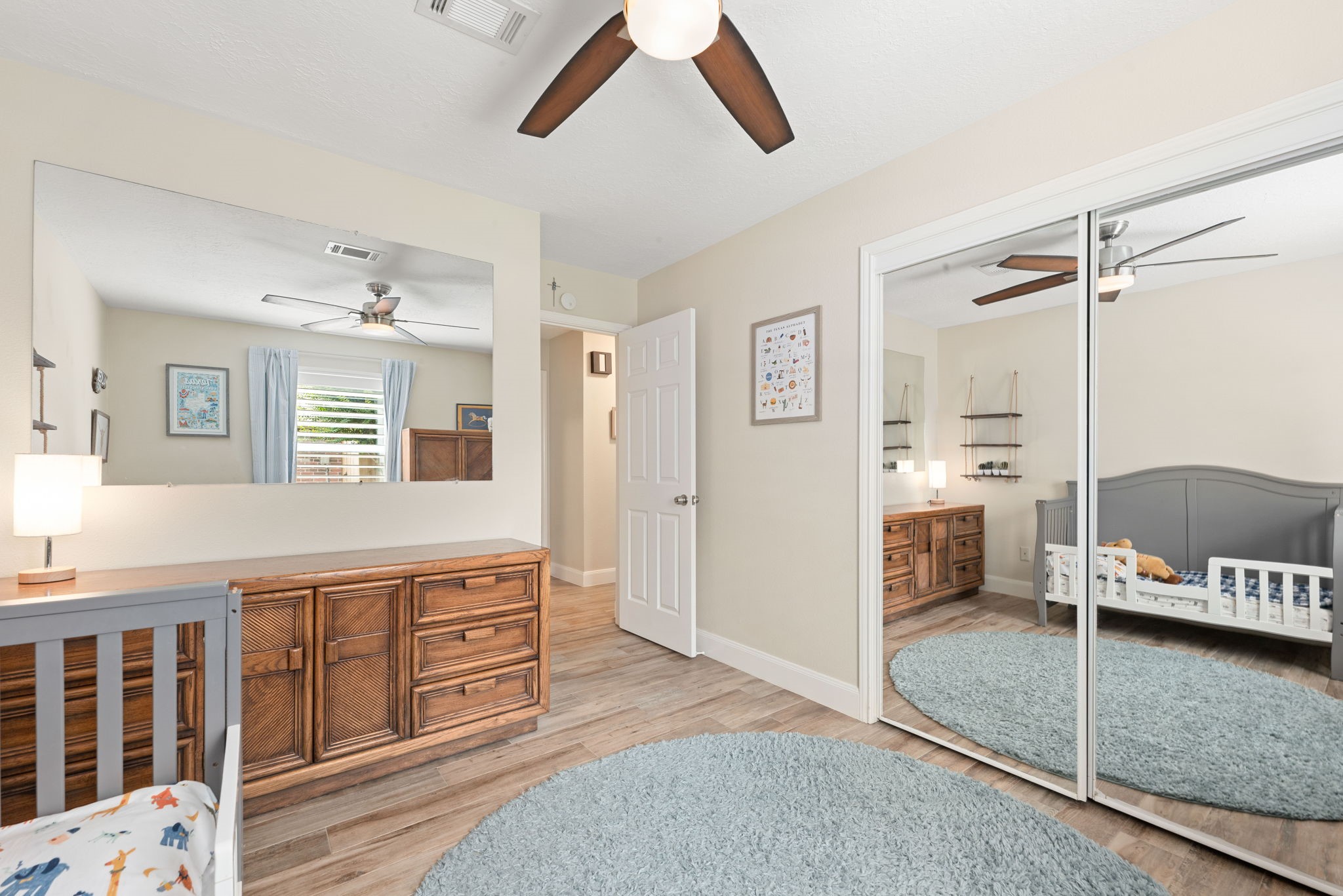 1915 Mercoal Drive Spring, TX 77386 - Photo 24 of 50 Spacious guest bedroom featuring mirrored closet doors and plenty of natural light.