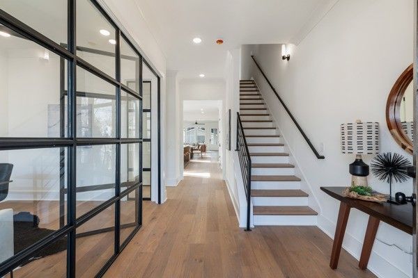 a view of staircase with a large window and wooden floor