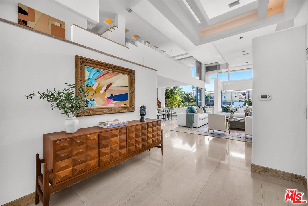 4911 Roma Court Marina del Rey, CA 90292 - Photo 3 of 58 a living room with furniture and a painting on the wall