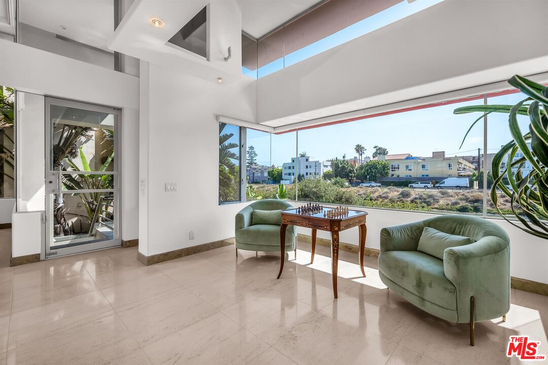 4911 Roma Court Marina del Rey, CA 90292 - Photo 7 of 58 a living room with furniture and a floor to ceiling window