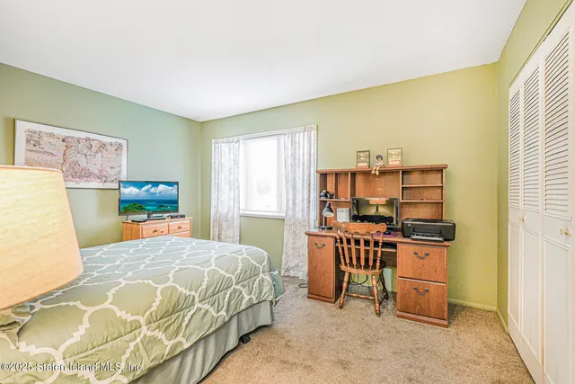 a bedroom with a bed and a cabinets