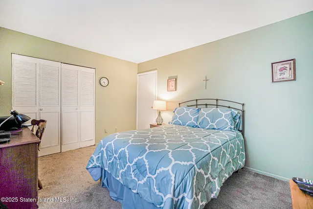 a bedroom with a bed and a mirror