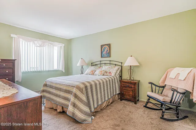 a bedroom with a bed and a chair