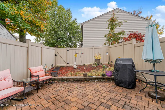 a backyard of a house with table and chairs