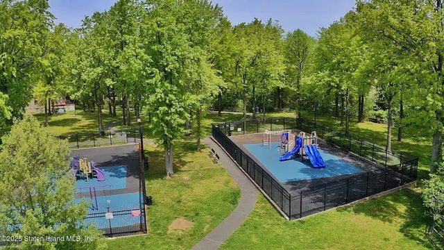 swimming pool view with a garden and trees