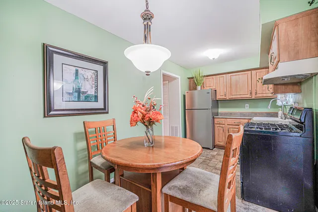 a view of a dining room with furniture and a chandelier