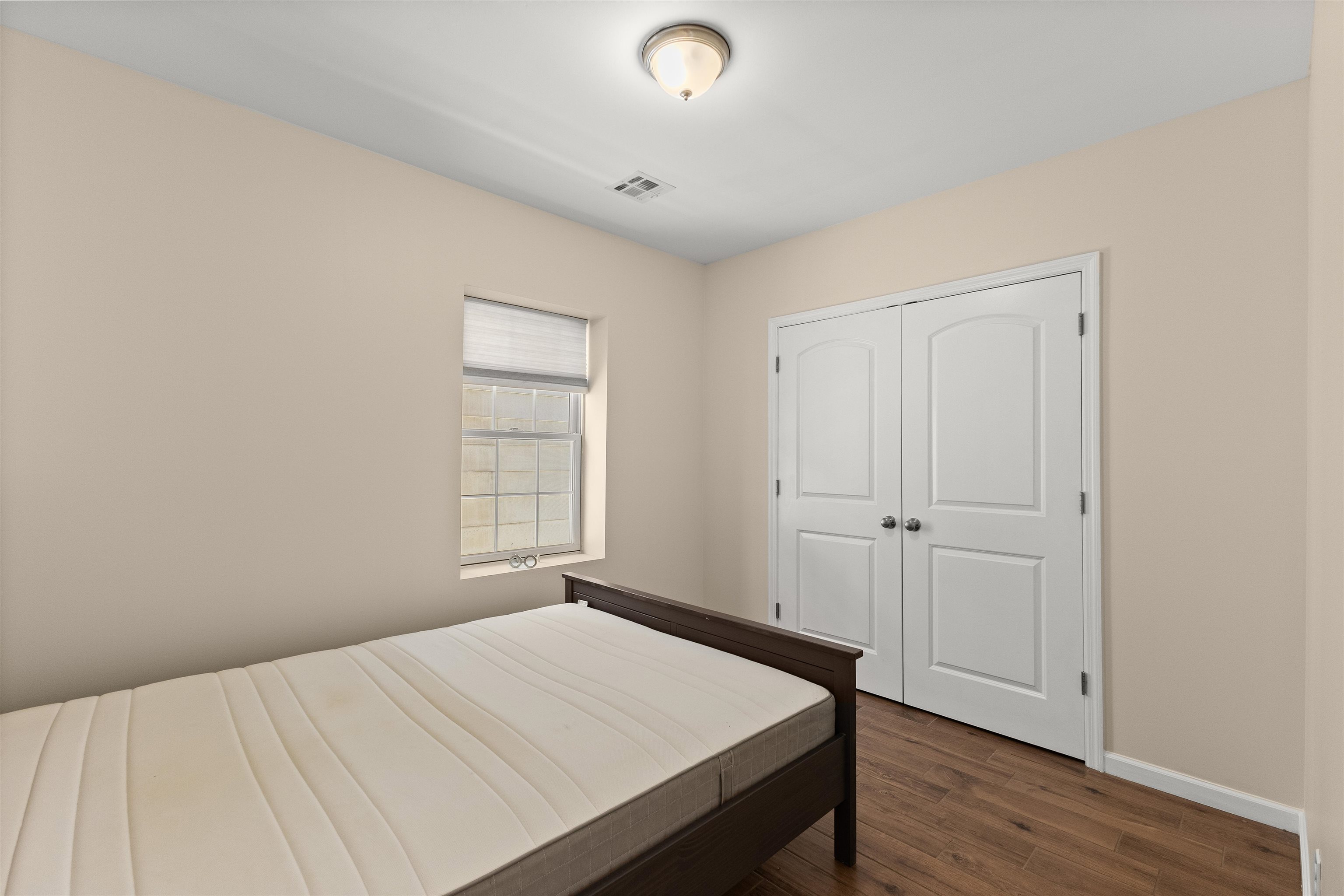 23 Reynolds Avenue, Unit 1 Harrison, NJ 07029 - Photo 12 of 23 a bedroom with a bed and a window