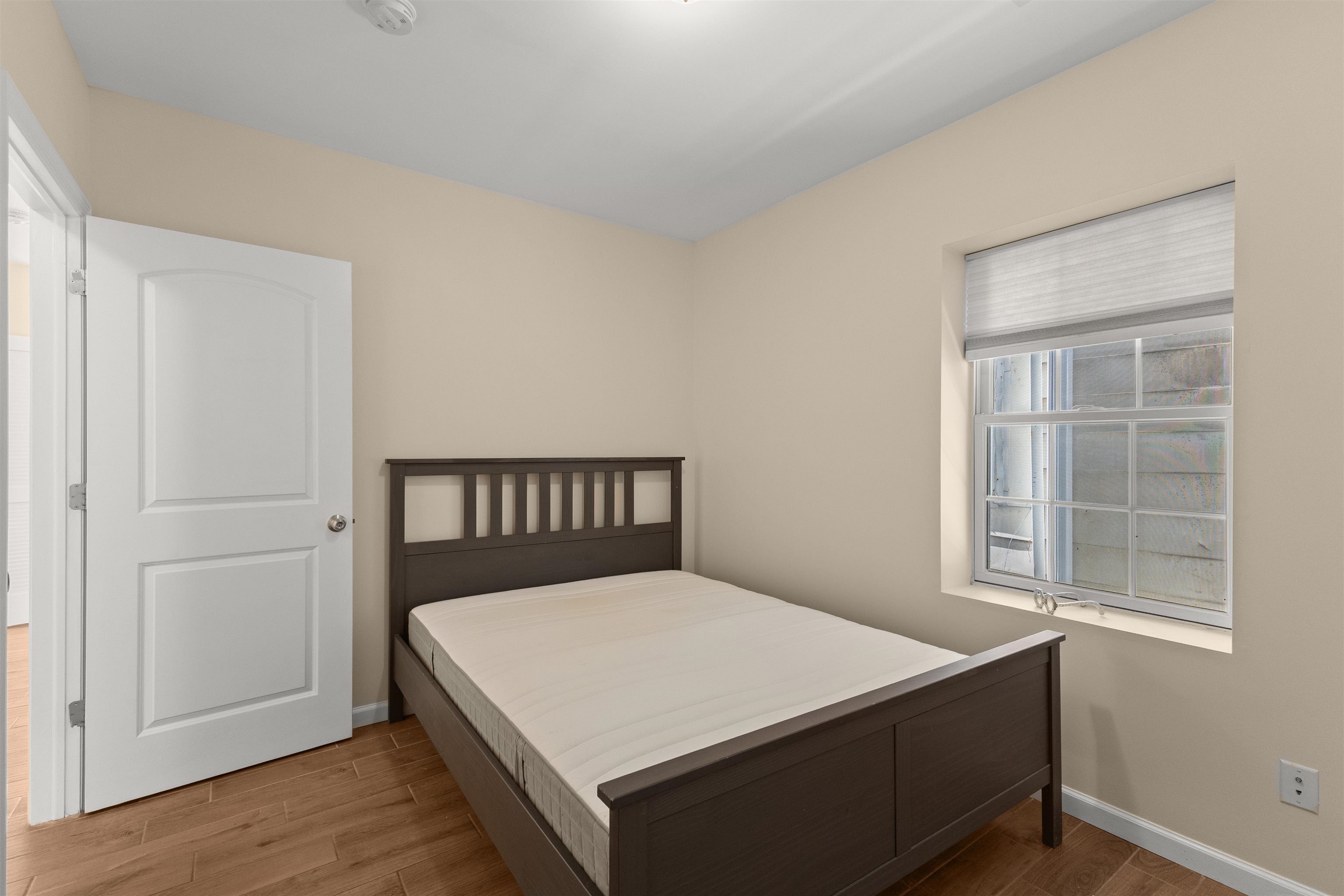 23 Reynolds Avenue, Unit 1 Harrison, NJ 07029 - Photo 13 of 23 a bed sitting in a bedroom next to a window
