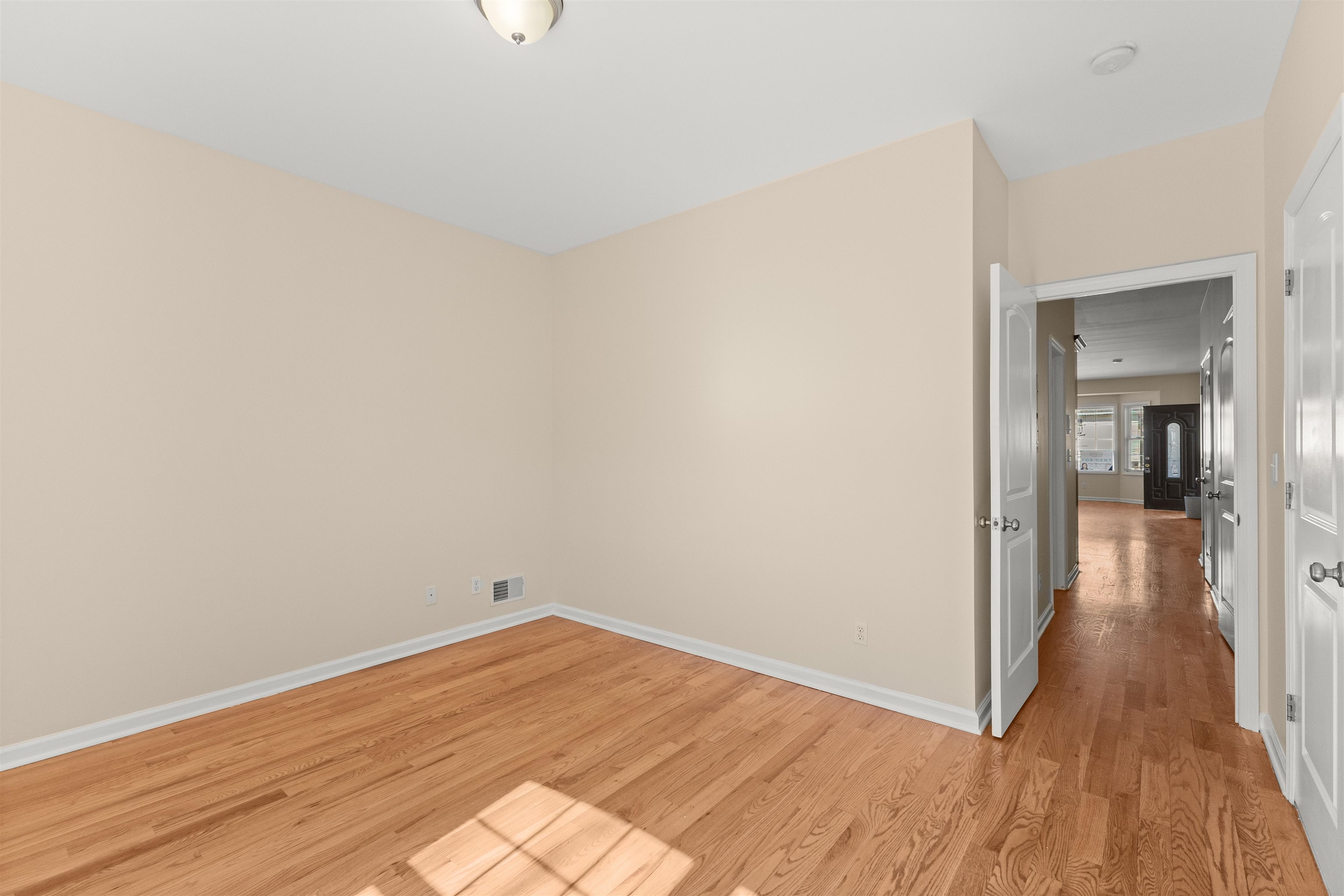 23 Reynolds Avenue, Unit 1 Harrison, NJ 07029 - Photo 15 of 23 a view of a room with wooden floor and bench