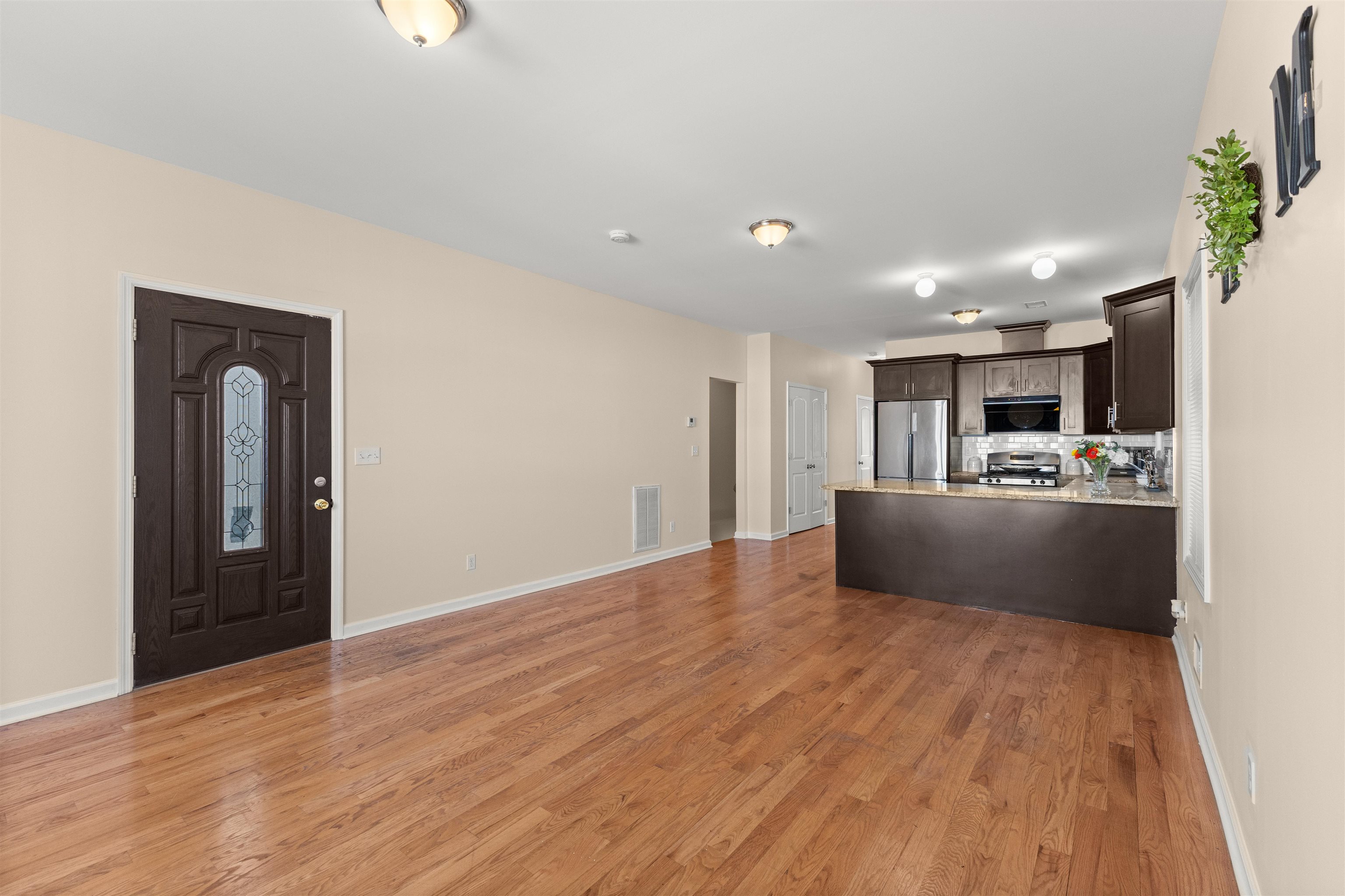 23 Reynolds Avenue, Unit 1 Harrison, NJ 07029 - Photo 4 of 23 a view of large kitchen with wooden floor