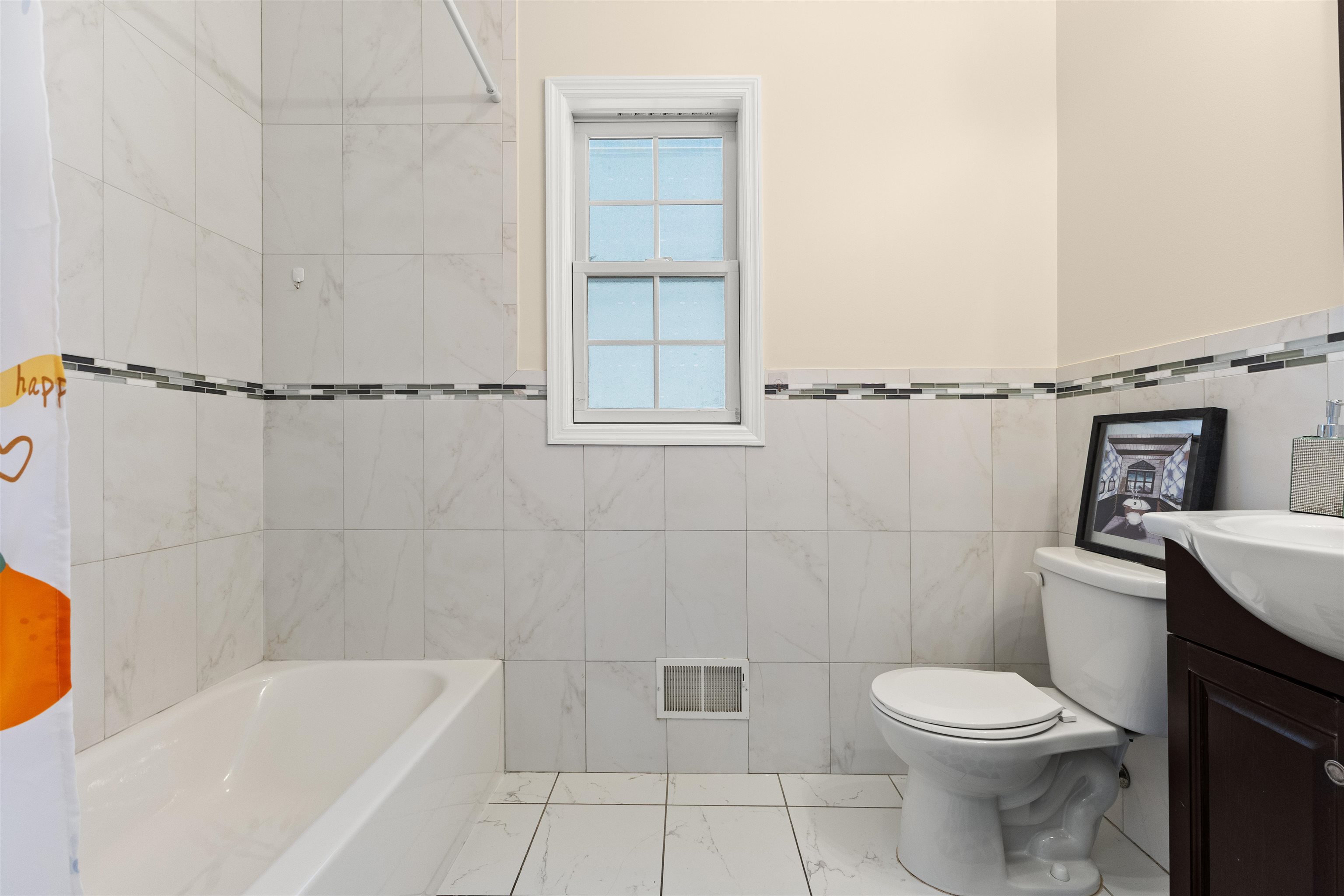 23 Reynolds Avenue, Unit 1 Harrison, NJ 07029 - Photo 7 of 23 a bathroom with a toilet a sink and bathtub