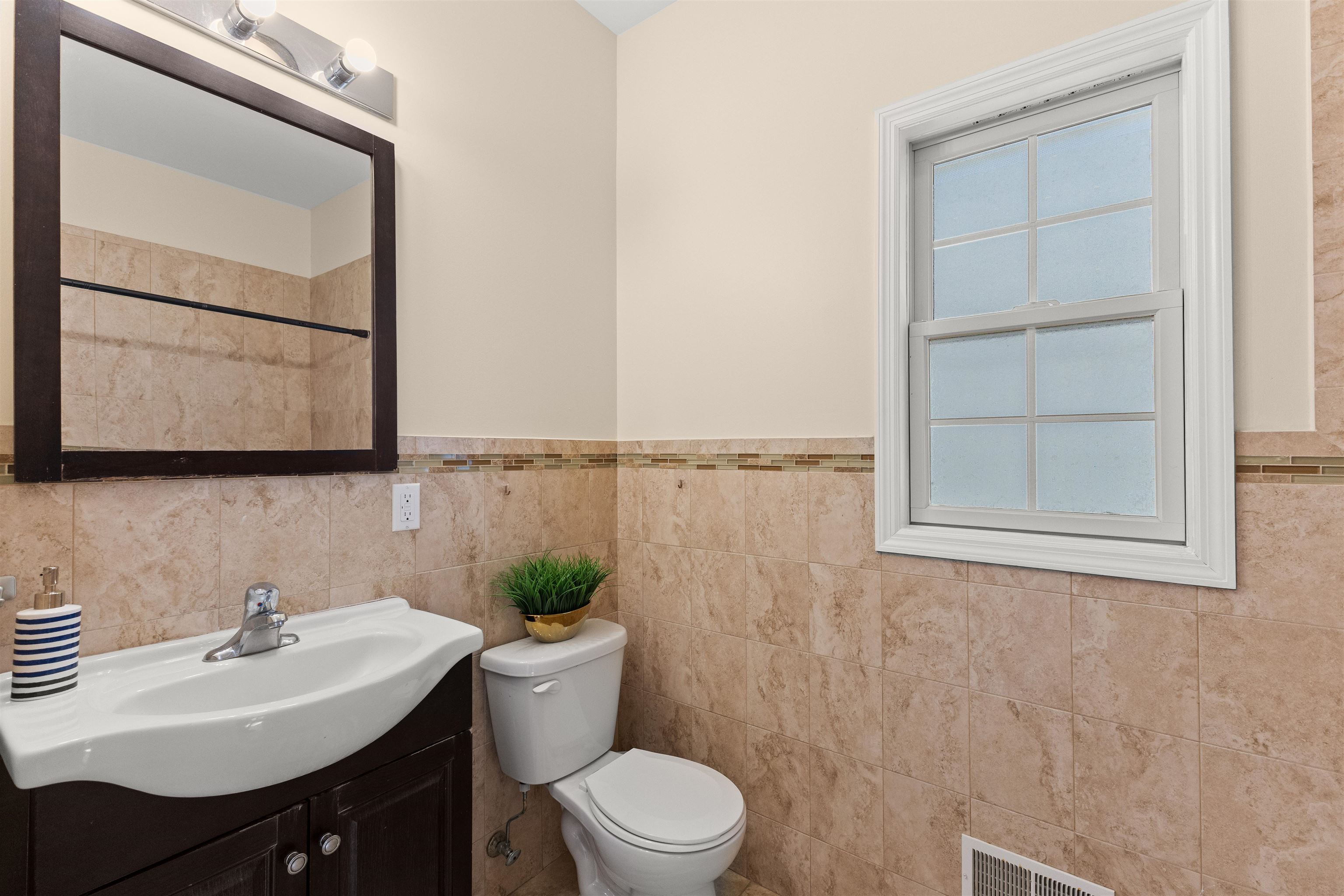 23 Reynolds Avenue, Unit 1 Harrison, NJ 07029 - Photo 10 of 23 a bathroom with a sink toilet and mirror