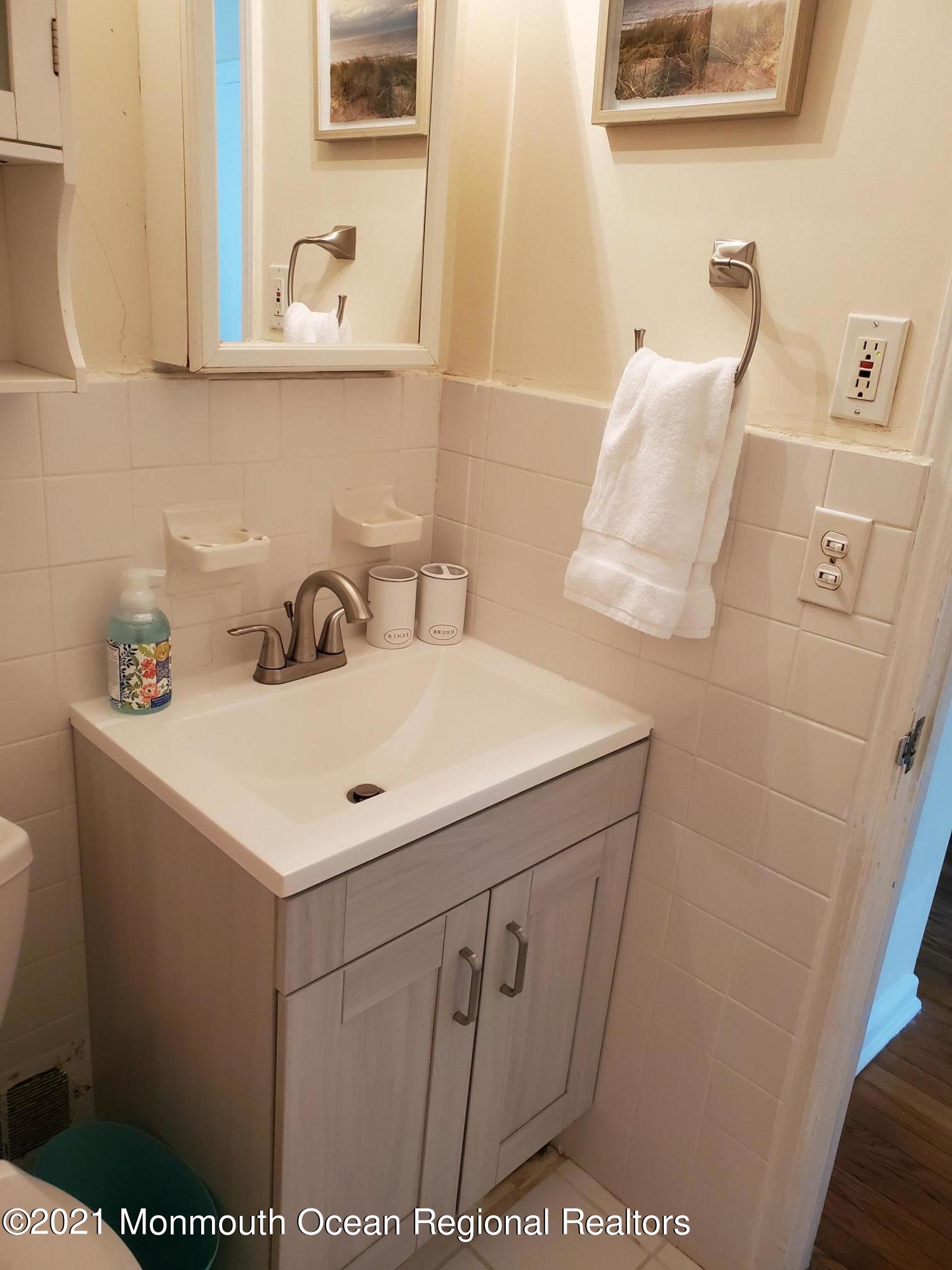 5 Calvert Avenue, Unit B Long Branch, NJ 07740 - Photo 4 of 12 a bathroom with a sink and a mirror