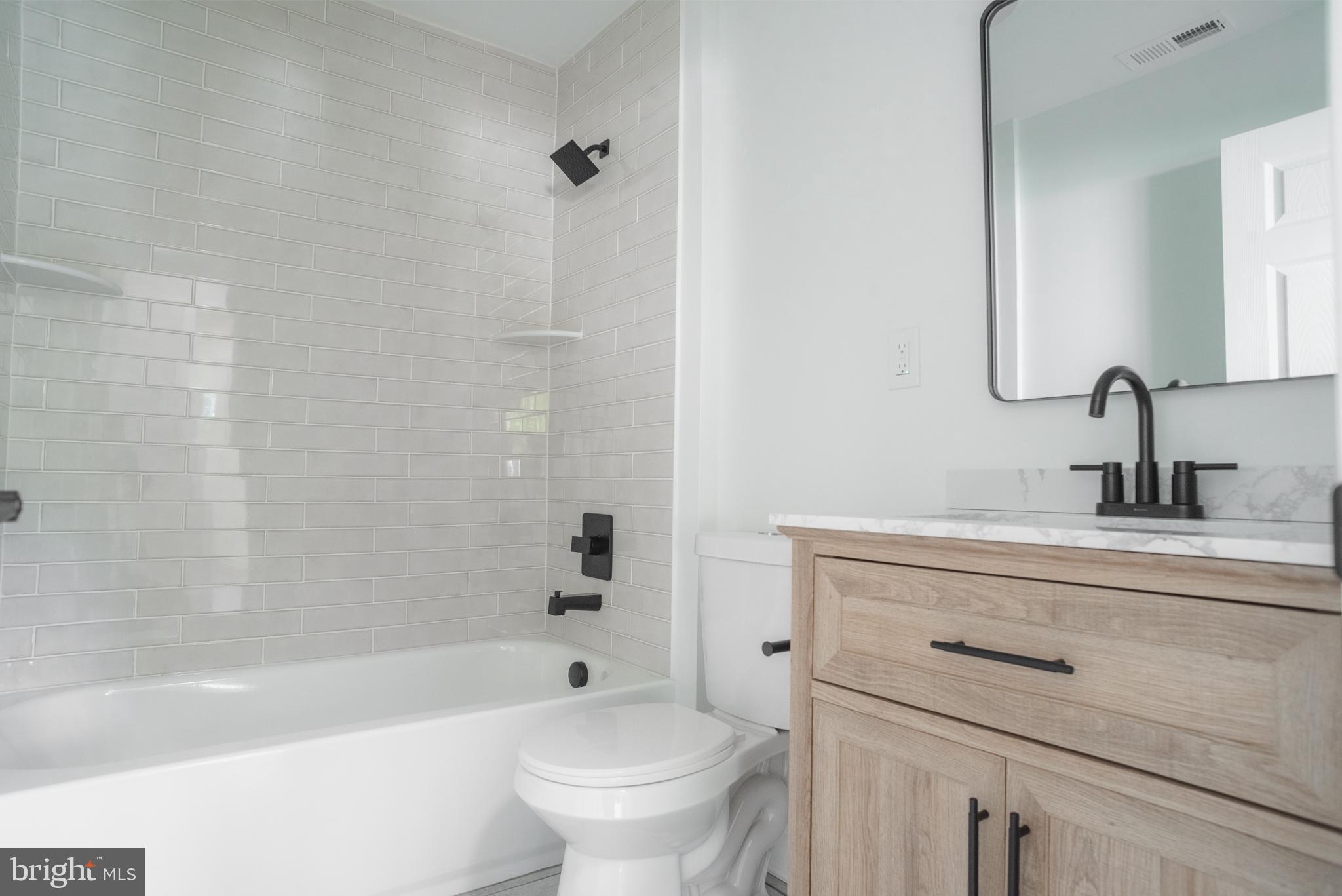 524 West Main Street Maple Shade, NJ 08052 - Photo 23 of 30 a bathroom with a sink a toilet a mirror a bathtub and shower