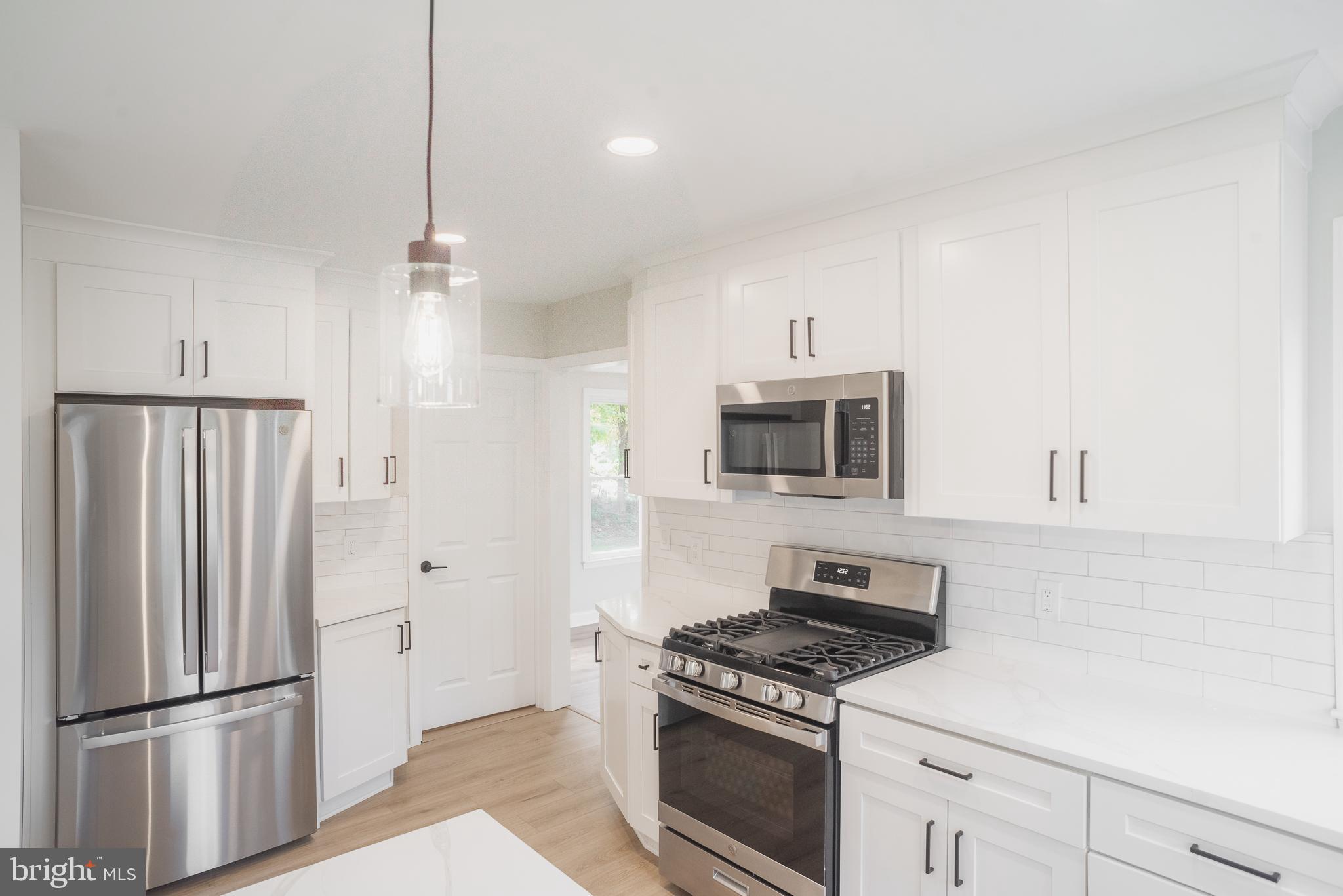 524 West Main Street Maple Shade, NJ 08052 - Photo 8 of 30 a kitchen with stainless steel appliances white cabinets and wooden floor