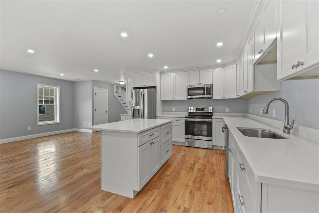 118 Thompson Road, Unit A Webster, MA 01570 - Photo 11 of 39 a large kitchen with stainless steel appliances granite countertop a stove and a sink