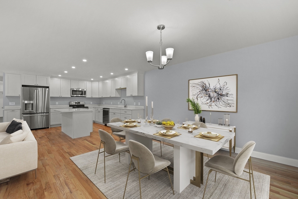 118 Thompson Road, Unit A Webster, MA 01570 - Photo 15 of 39 a dining room with wooden floor and kitchen view