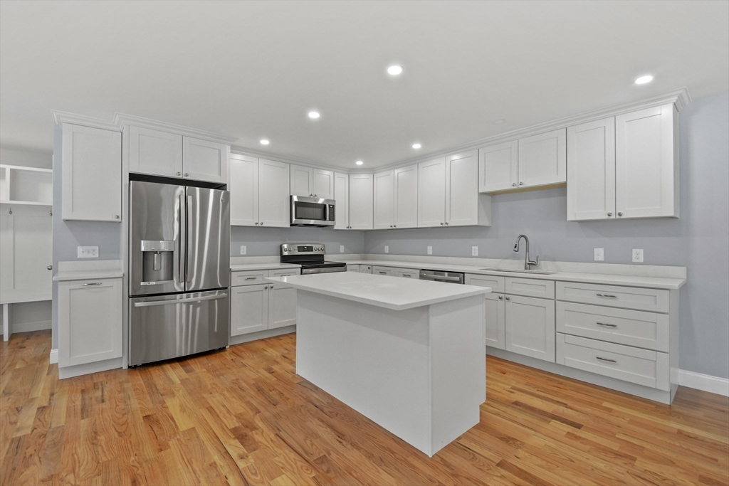 118 Thompson Road, Unit A Webster, MA 01570 - Photo 10 of 39 a kitchen with a refrigerator stove top oven and cabinets