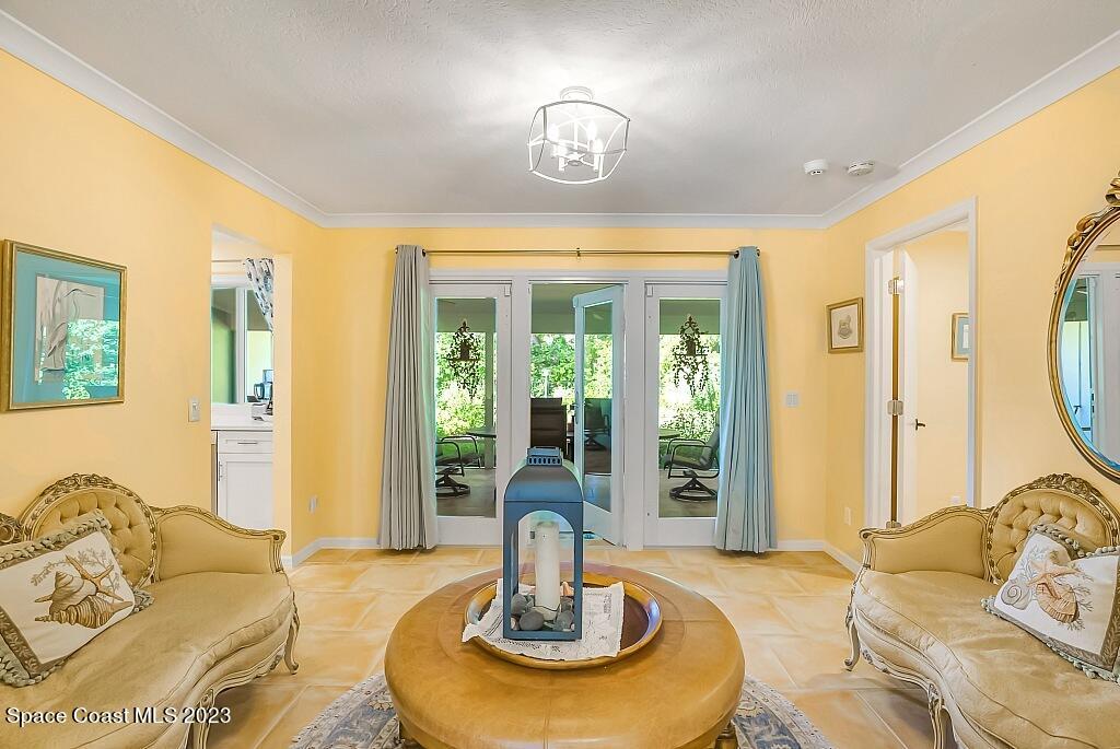 4307 2nd Square Southwest Vero Beach, FL 32968 - Photo 15 of 46 a living room with fireplace furniture and a chandelier
