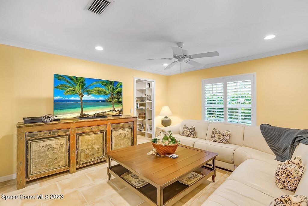 4307 2nd Square Southwest Vero Beach, FL 32968 - Photo 38 of 46 a living room with furniture a flat screen tv and a large window