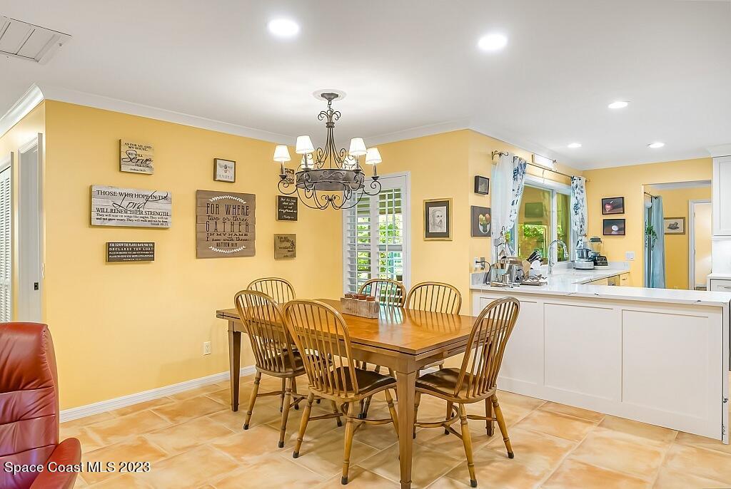 4307 2nd Square Southwest Vero Beach, FL 32968 - Photo 39 of 46 a view of a dining room with furniture and chandelier
