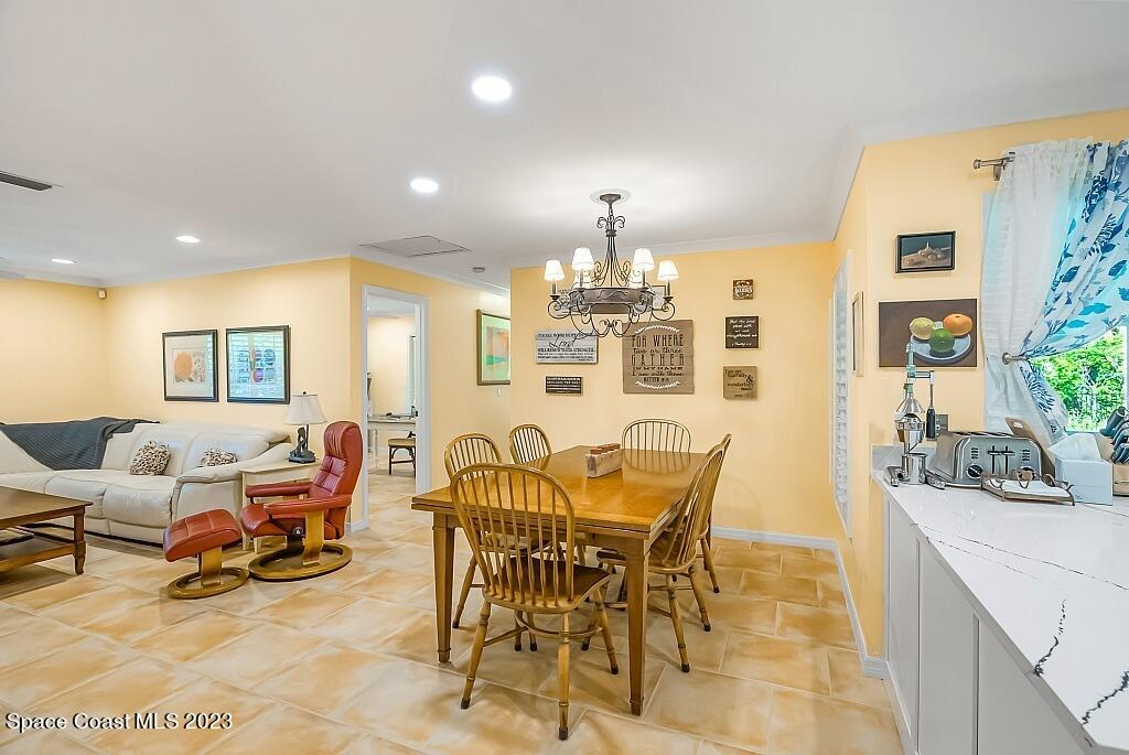 4307 2nd Square Southwest Vero Beach, FL 32968 - Photo 40 of 46 a view of a dining room with furniture and chandelier