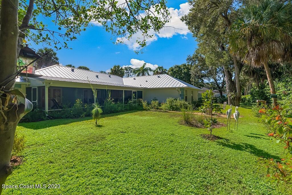 4307 2nd Square Southwest Vero Beach, FL 32968 - Photo 5 of 46 a front view of a house with a yard table and chairs