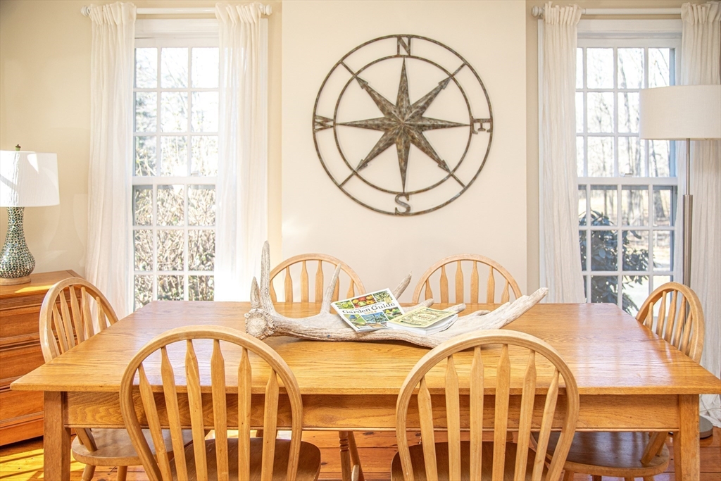 435 Market Hill Road Amherst, MA 01002 - Photo 8 of 42 a view of a dining room with furniture a chandelier and wooden floor