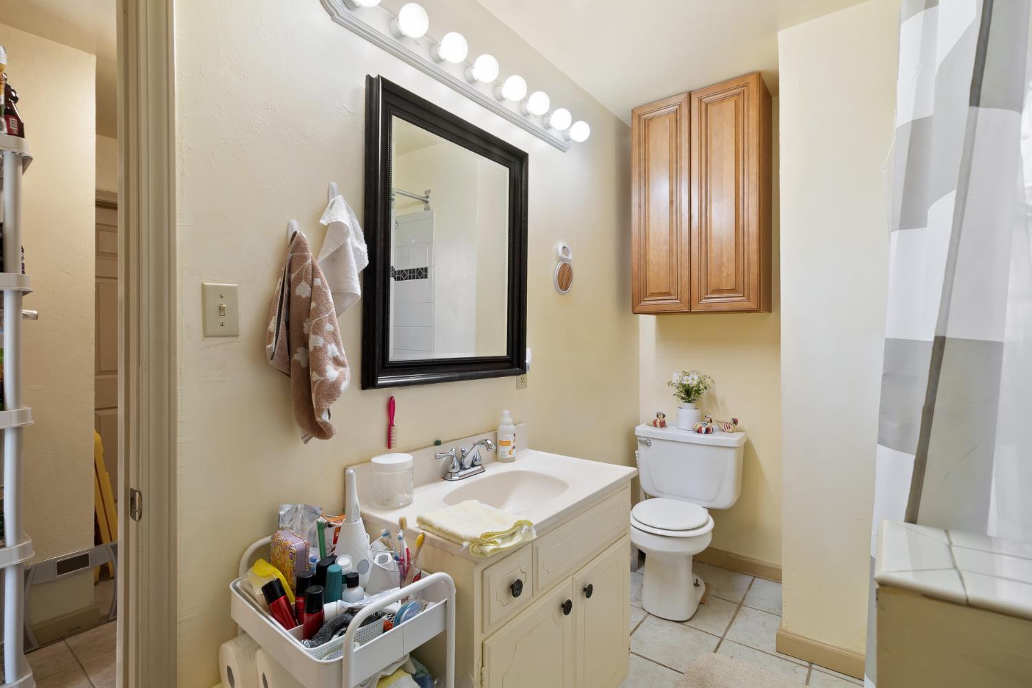 504 West Marlette Street Ione, CA 95640 - Photo 22 of 53 a bathroom with a toilet sink and mirror