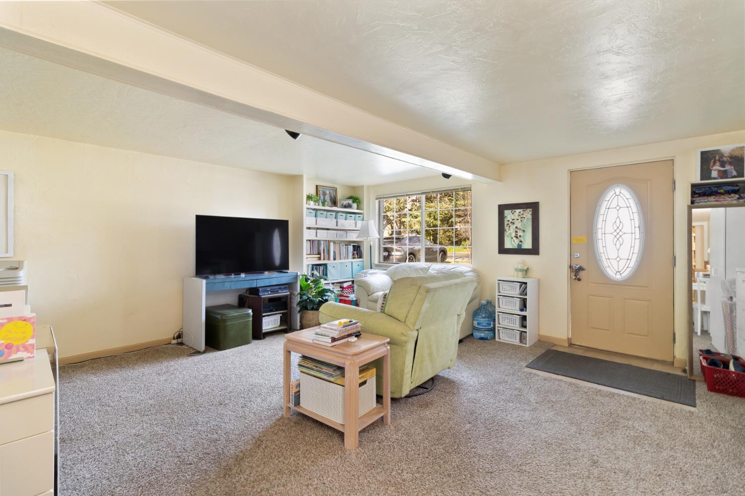 504 West Marlette Street Ione, CA 95640 - Photo 4 of 53 a living room with furniture a flat screen tv and a window